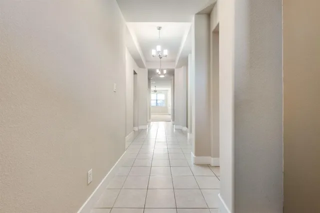 a view of a kitchen with center island stainless steel appliances wooden floor and a window