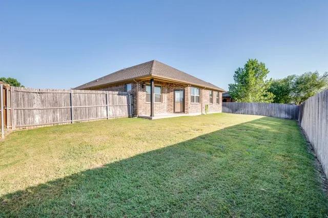 an empty room with a ceiling fan and a window