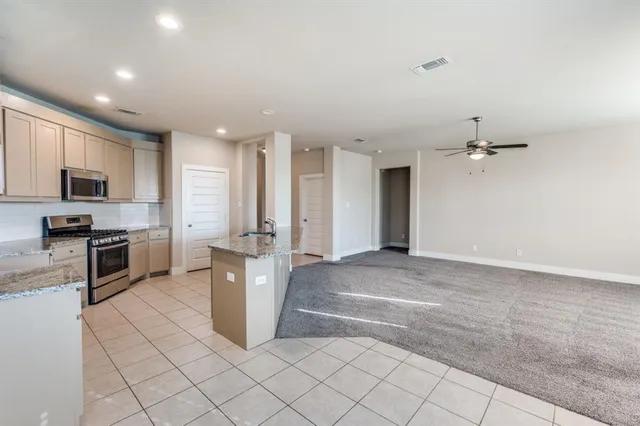 a view of a kitchen with microwave and cabinets