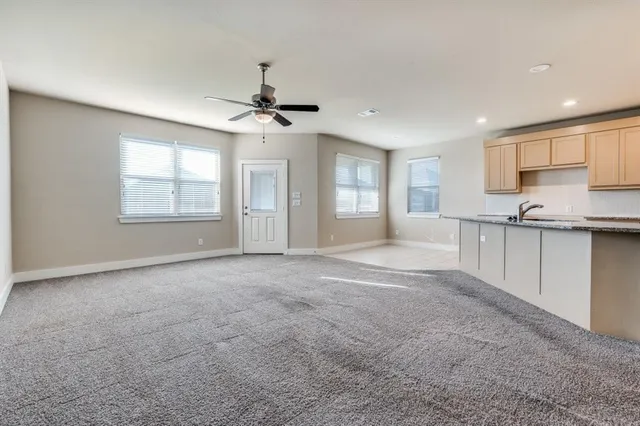 a view of an empty room with window and cabinet