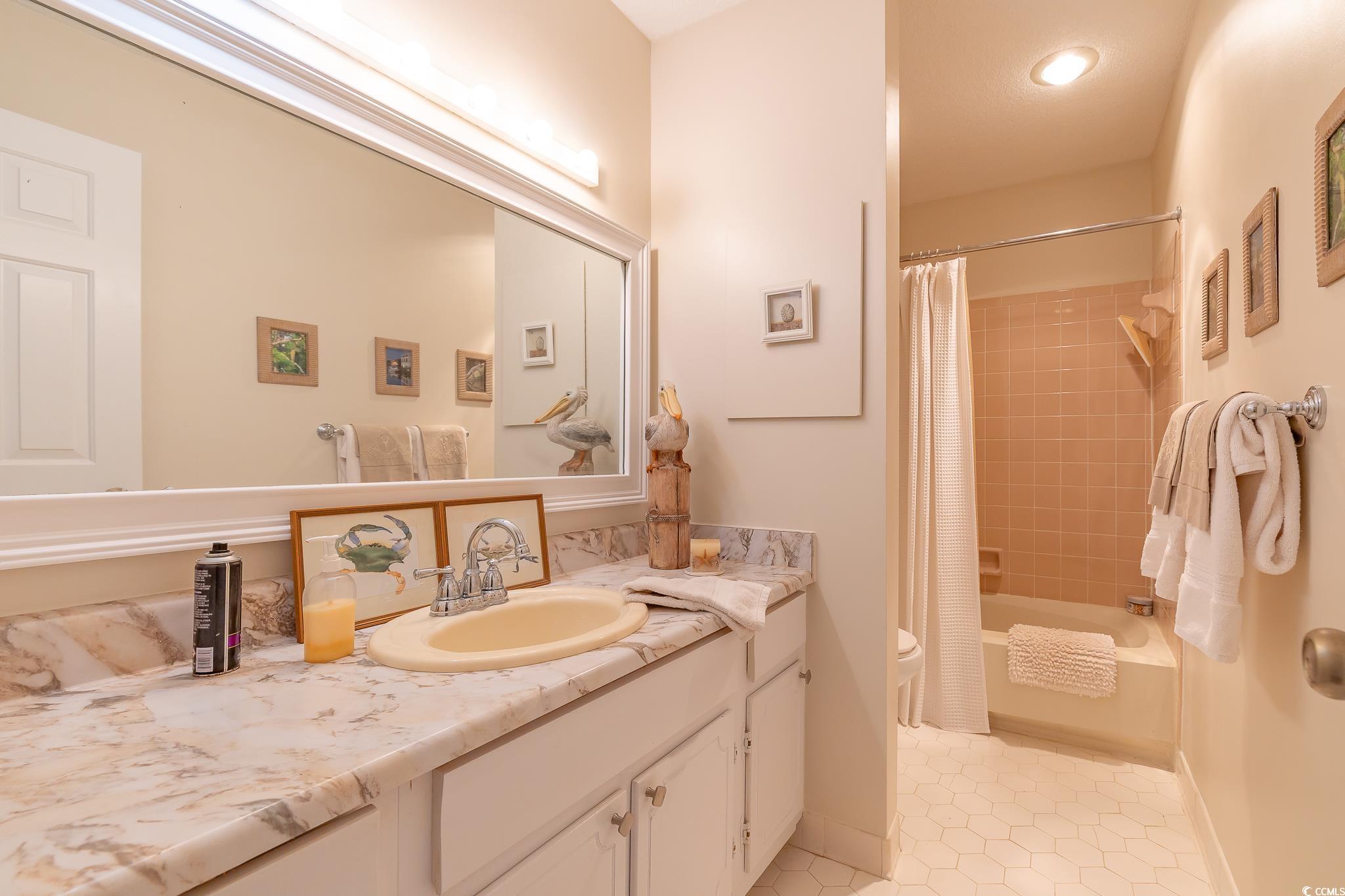 117 Finch Drive, Unit 272 Georgetown, SC 29440 - Photo 17 of 36 Full bathroom with vanity, shower / bath combination with curtain, and light tile patterned floors