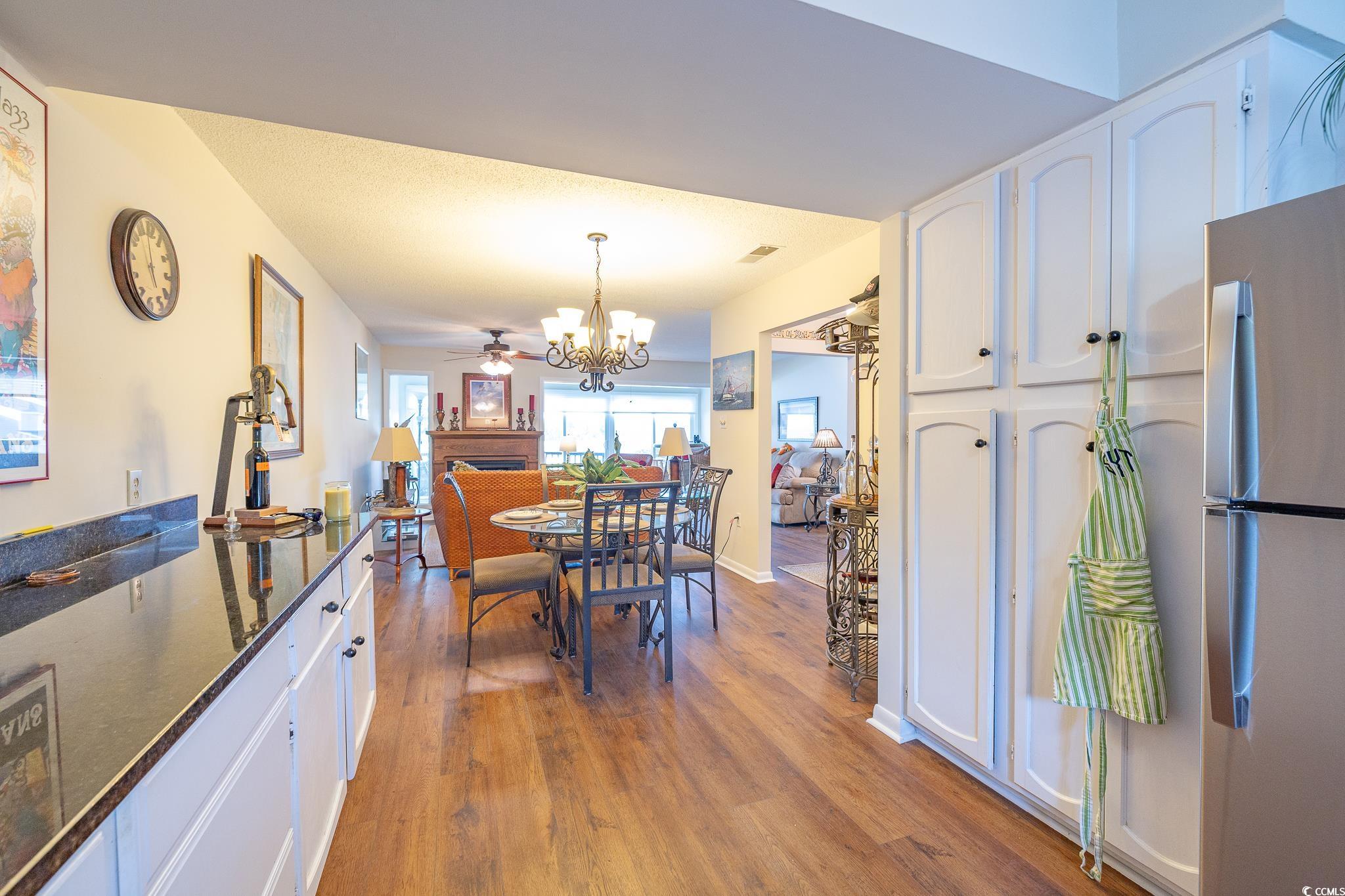 117 Finch Drive, Unit 272 Georgetown, SC 29440 - Photo 27 of 36 Dining space with dark wood-style flooring, a ceiling fan, and a chandelier