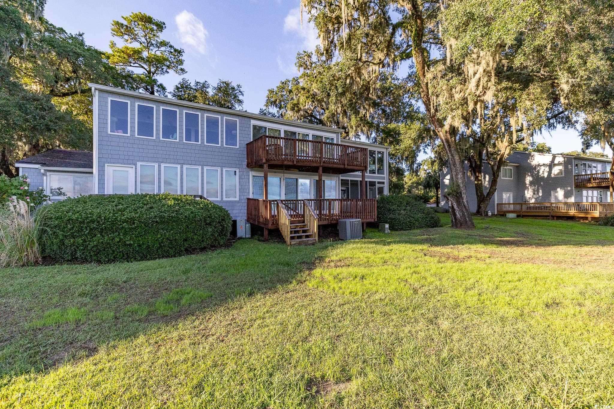 117 Finch Drive, Unit 272 Georgetown, SC 29440 - Photo 6 of 36 Rear view of house with a deck and a lawn