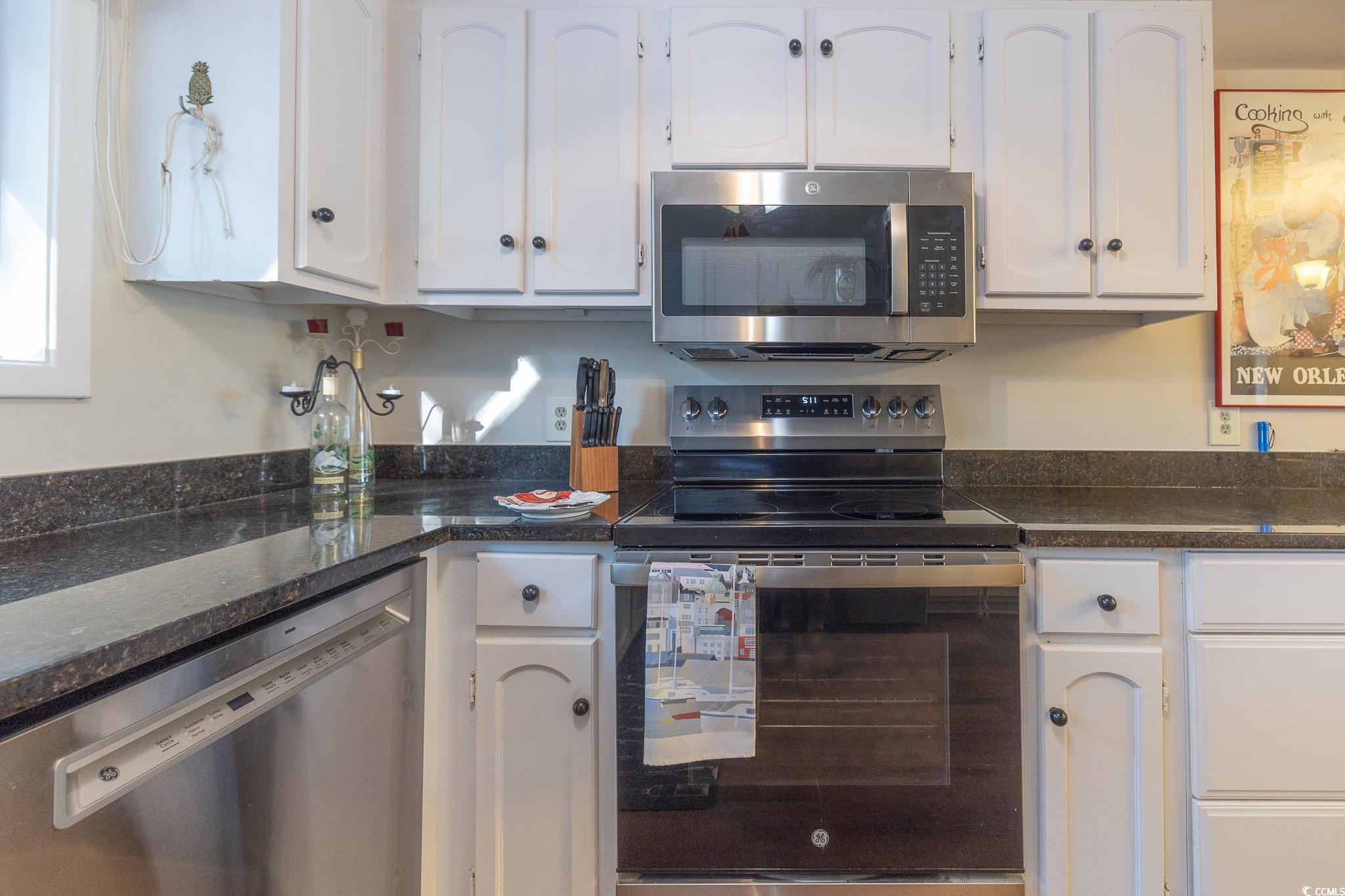 117 Finch Drive, Unit 272 Georgetown, SC 29440 - Photo 8 of 36 Kitchen featuring appliances with stainless steel finishes, white cabinets, and dark stone countertops