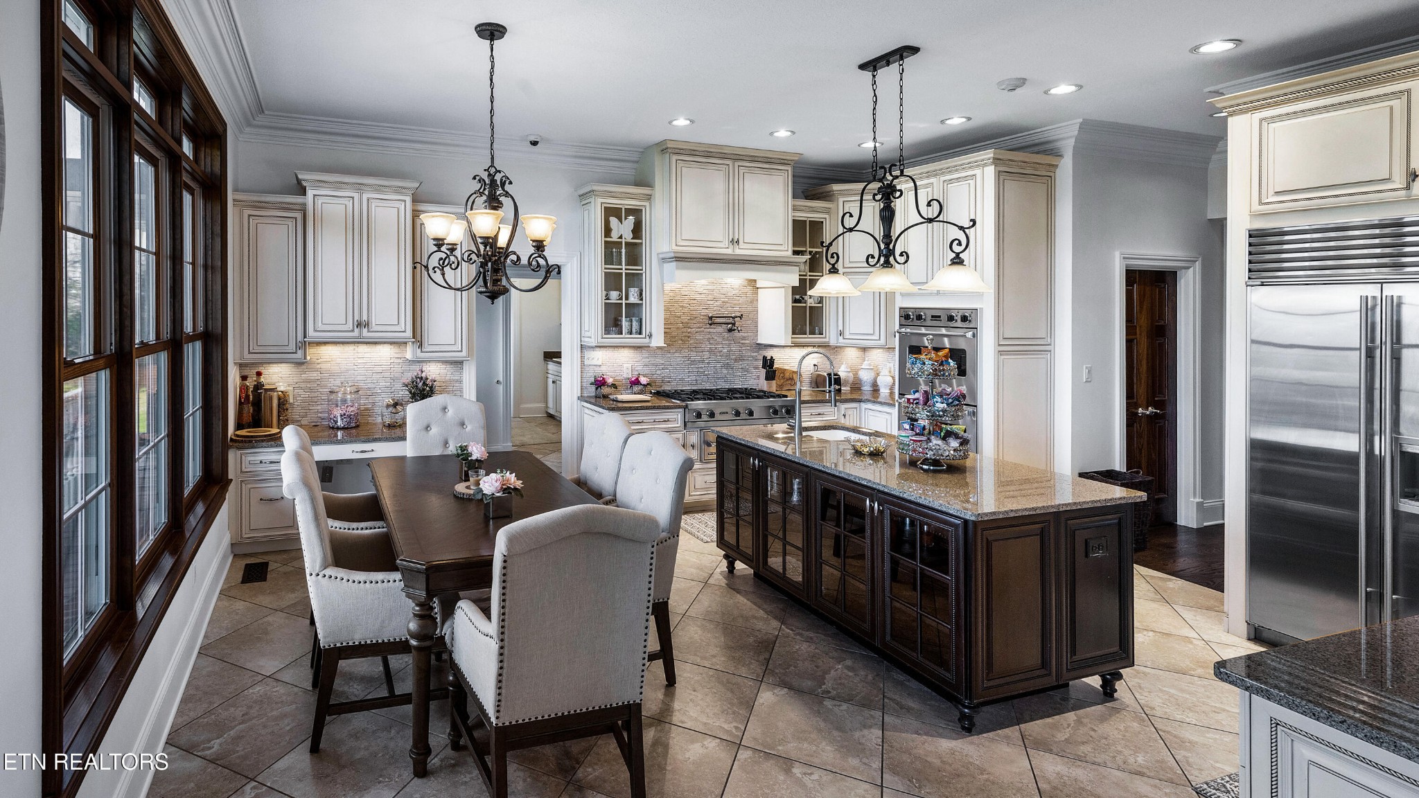 3050 Sims Road Sevierville, TN 37876 - Photo 22 of 59 a kitchen with stainless steel appliances kitchen island granite countertop a table chairs and a refrigerator