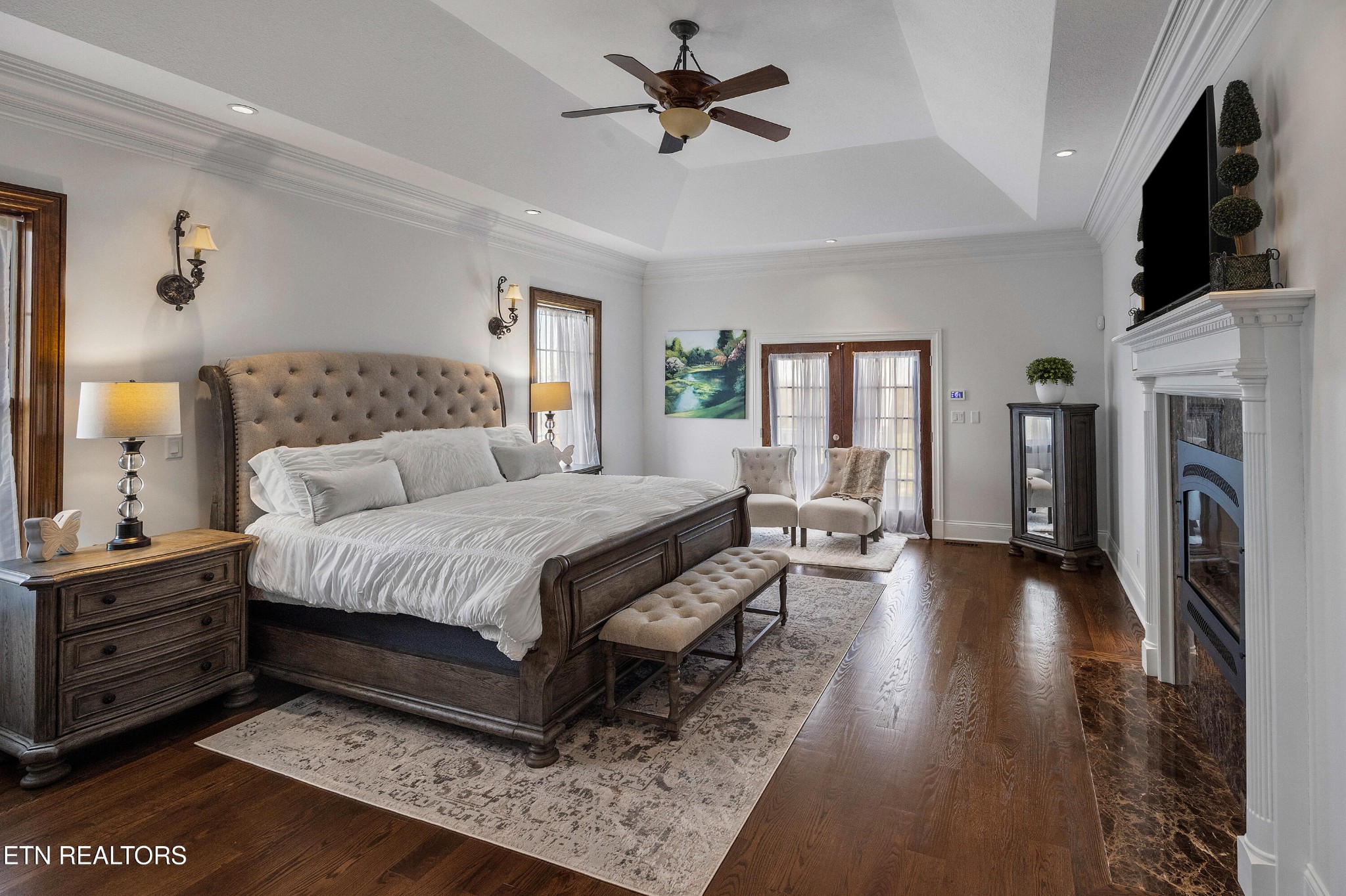 3050 Sims Road Sevierville, TN 37876 - Photo 36 of 59 a spacious bedroom with a bed a fireplace and a chandelier