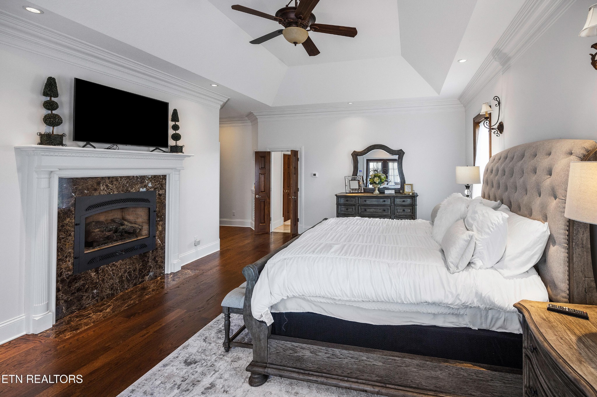 3050 Sims Road Sevierville, TN 37876 - Photo 38 of 59 a bedroom with a bed and a fireplace