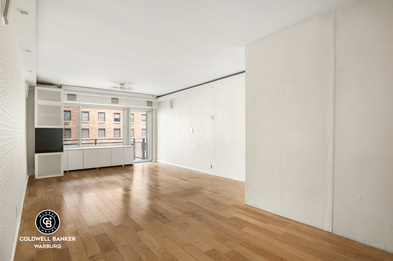 118 East 60th Street, Unit 7B Manhattan, NY 10022 - Photo 2 of 15 a view of a refrigerator in kitchen and a window