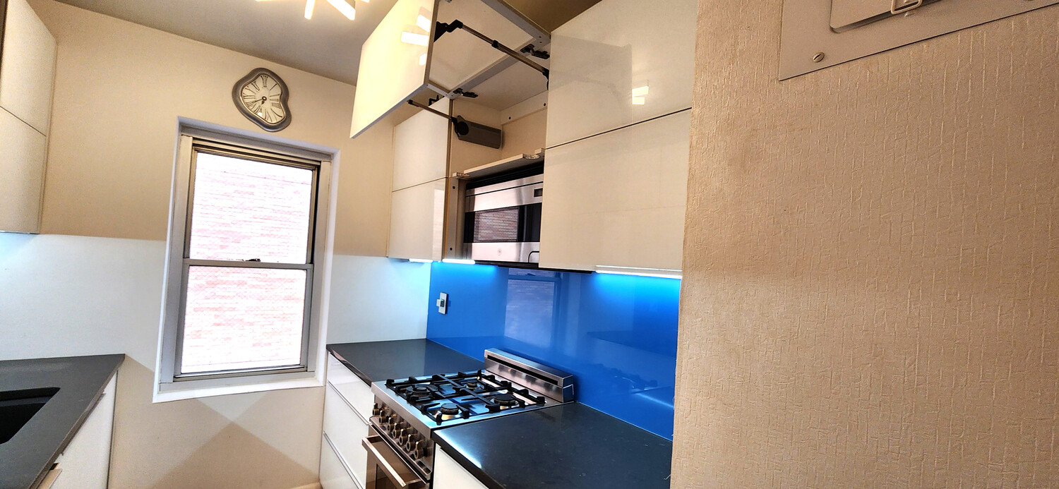 118 East 60th Street, Unit 7B Manhattan, NY 10022 - Photo 8 of 15 a view of kitchen with cabinets and window