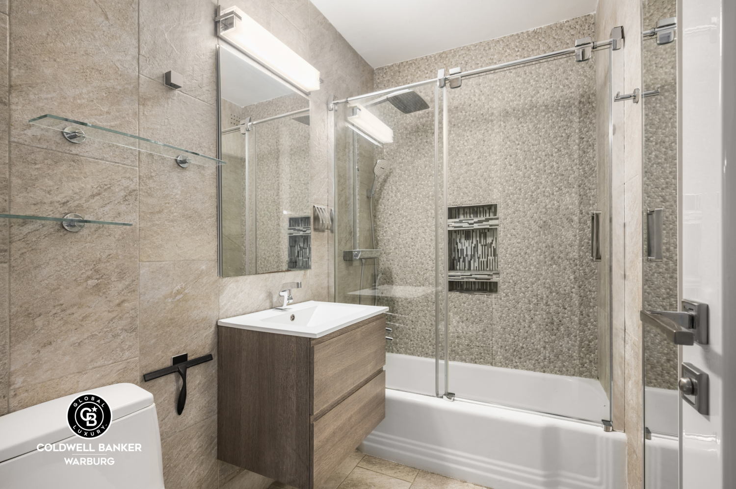 118 East 60th Street, Unit 7B Manhattan, NY 10022 - Photo 9 of 15 a bathroom with a sink and a mirror