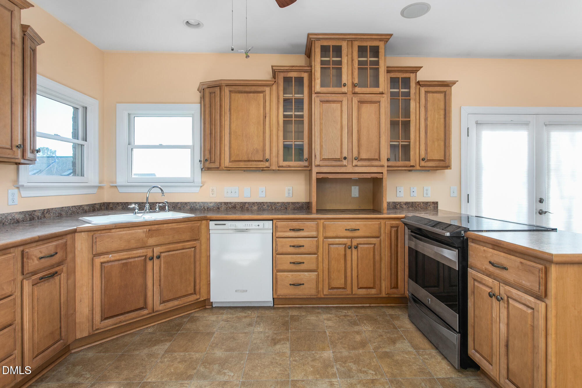 520 Grandview Drive Graham, NC 27253 - Photo 16 of 32 a large kitchen with granite countertop a sink and dishwasher a stove top oven with wooden floor