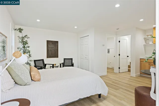 a kitchen with stainless steel appliances a stove a sink cabinets and a wooden floor