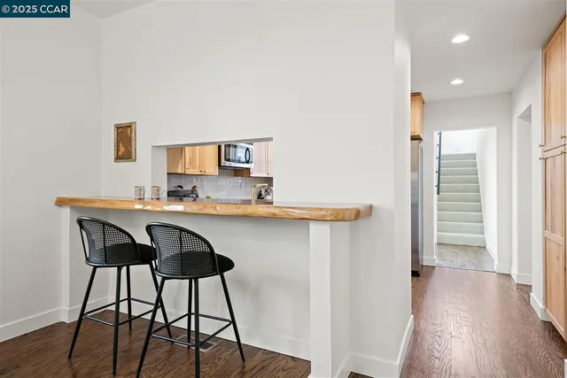 a kitchen with stainless steel appliances granite countertop a stove a sink dishwasher and a microwave oven with white cabinets