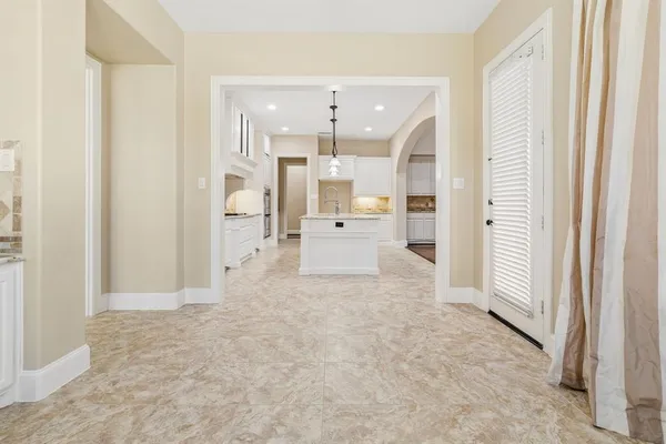 a view of a hallway with white doors
