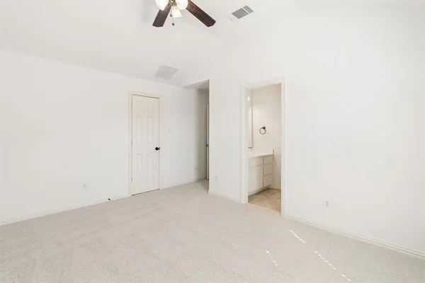 an empty room with ceiling fan