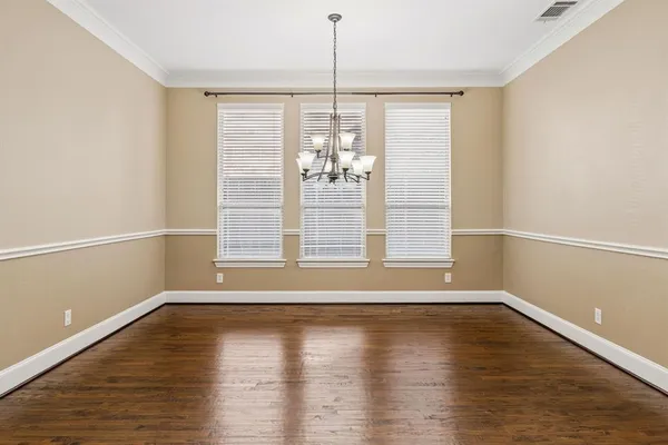 a view of a room with wooden floor and window