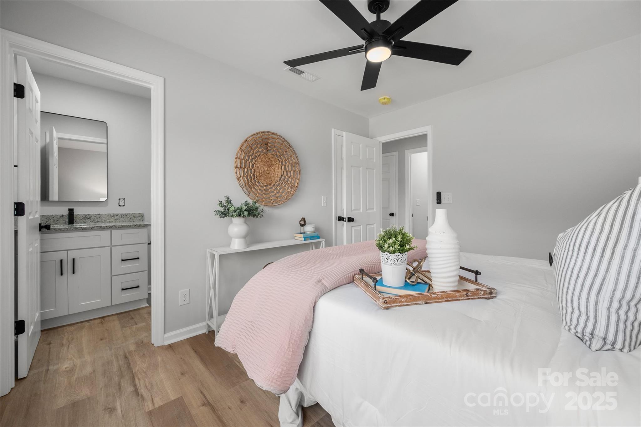 756 Logan Street Mooresville, NC 28115 - Photo 15 of 30 a bedroom with a bed and a chandelier