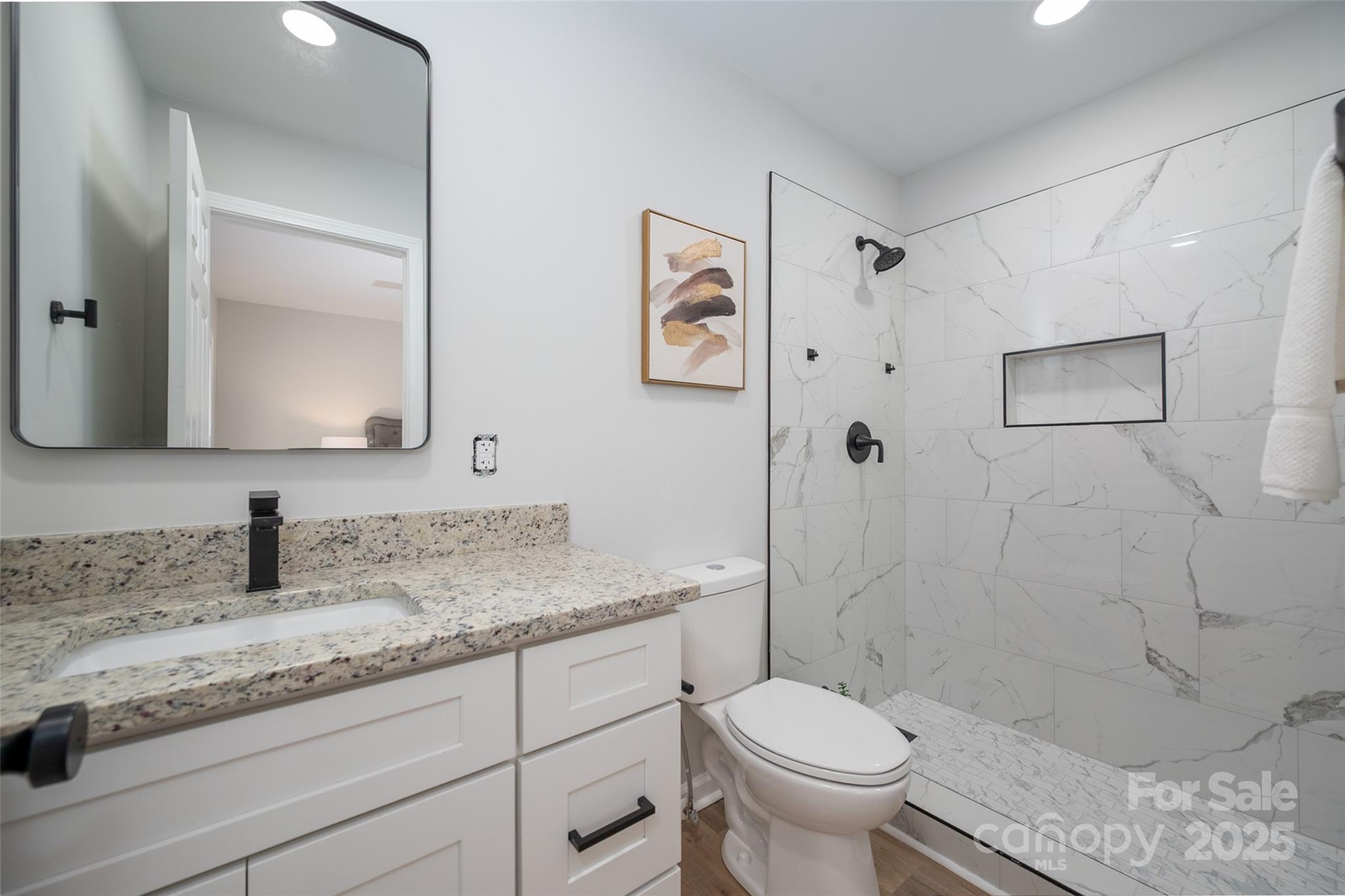 756 Logan Street Mooresville, NC 28115 - Photo 16 of 30 a bathroom with a granite countertop sink toilet and shower