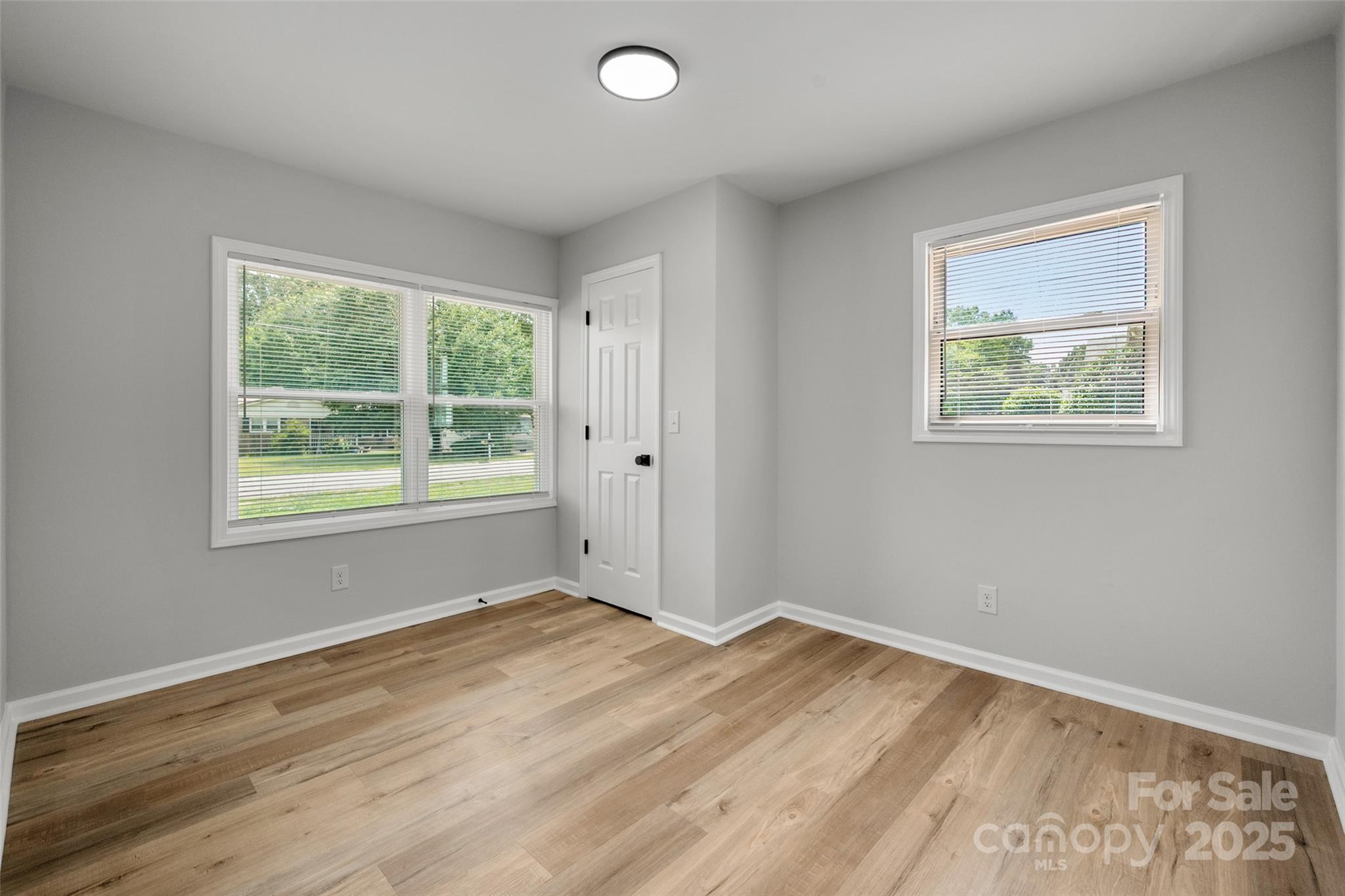 756 Logan Street Mooresville, NC 28115 - Photo 17 of 30 a view of an empty room with wooden floor and a window