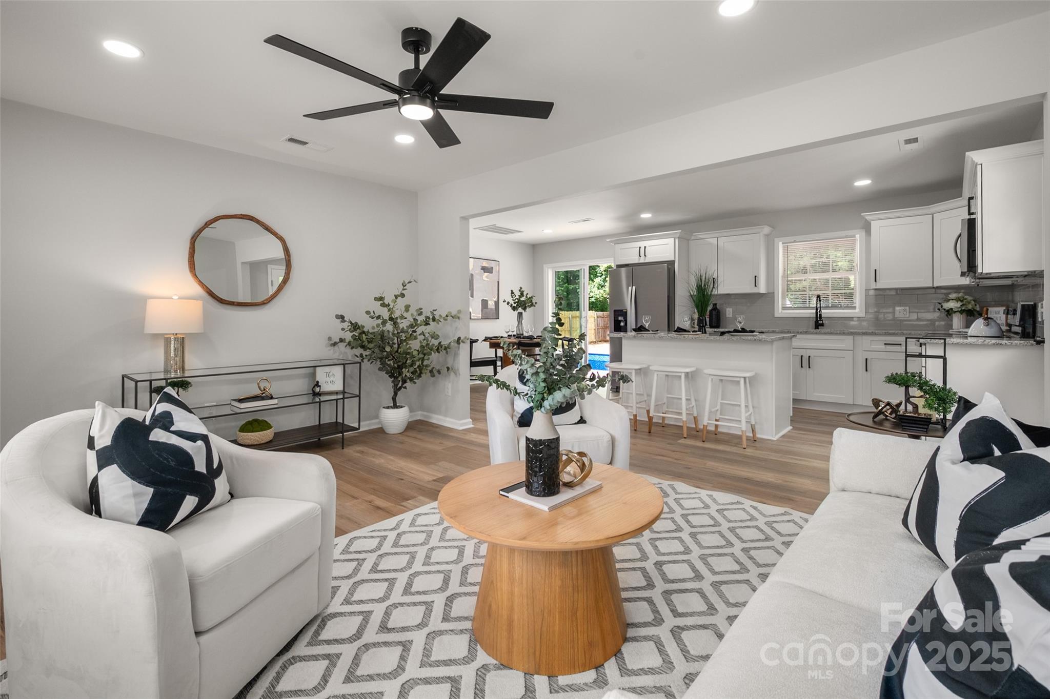 756 Logan Street Mooresville, NC 28115 - Photo 6 of 30 a living room with fireplace furniture and a wooden floor