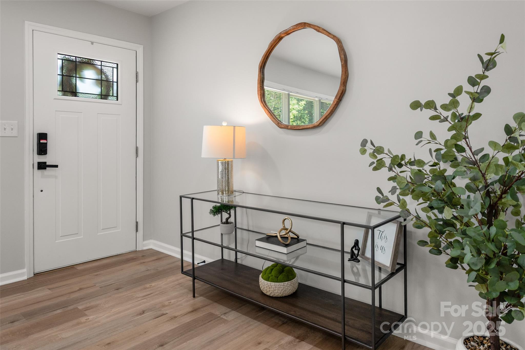 756 Logan Street Mooresville, NC 28115 - Photo 7 of 30 an entryway with wooden floor and front door