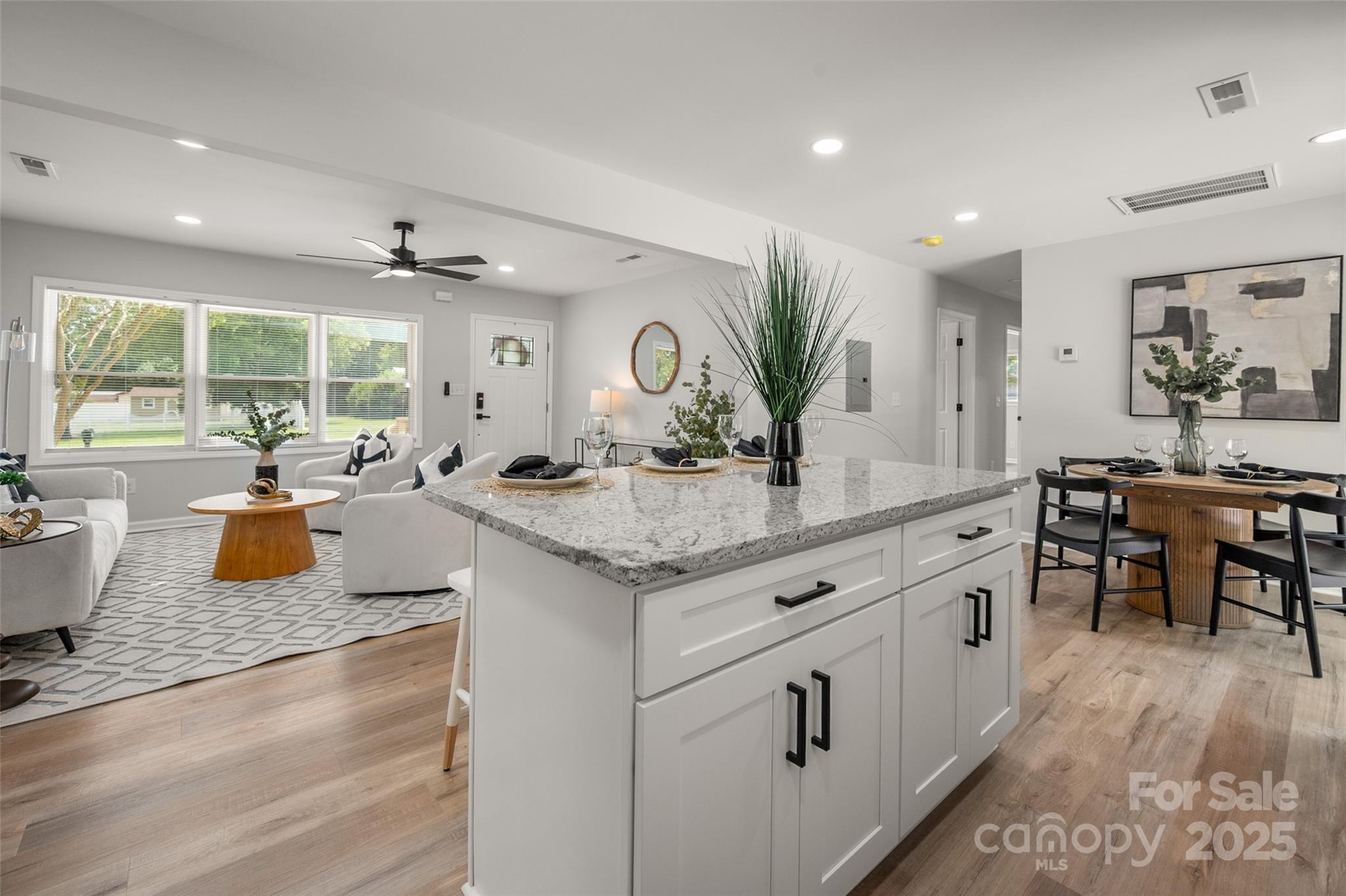 756 Logan Street Mooresville, NC 28115 - Photo 10 of 30 a large kitchen with granite countertop a large counter top and stainless steel appliances