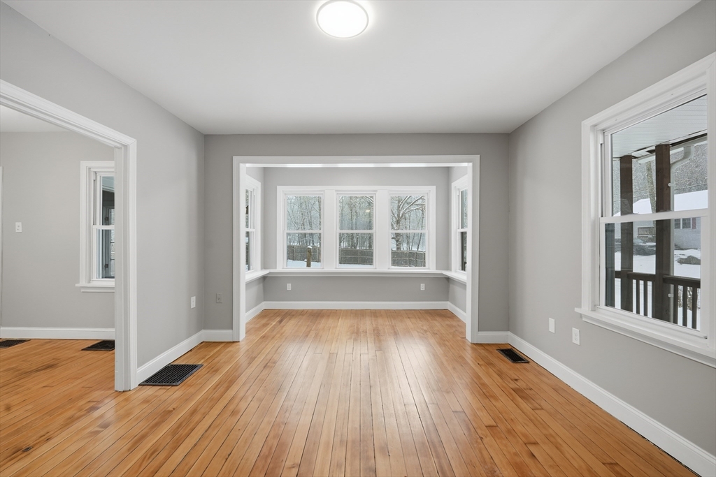 1209 Brimfield Road Warren, MA 01083 - Photo 12 of 41 a view of an empty room with wooden floor and a window