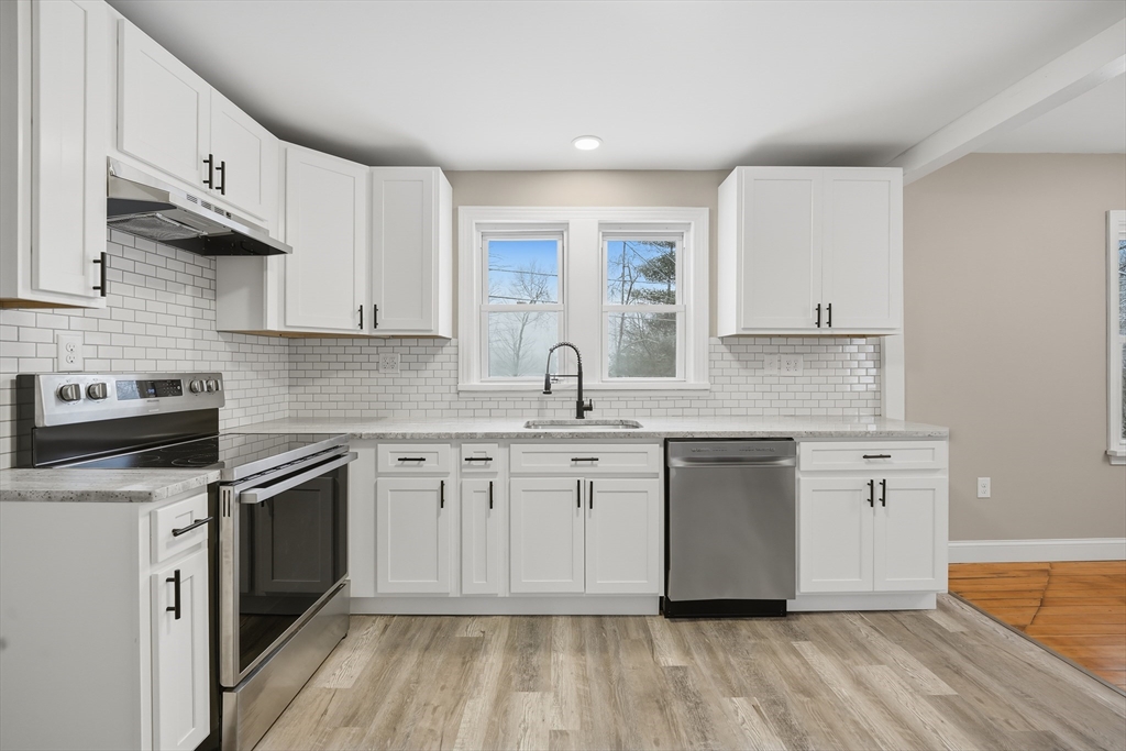 1209 Brimfield Road Warren, MA 01083 - Photo 3 of 41 a kitchen with stainless steel appliances granite countertop a sink stove and cabinets