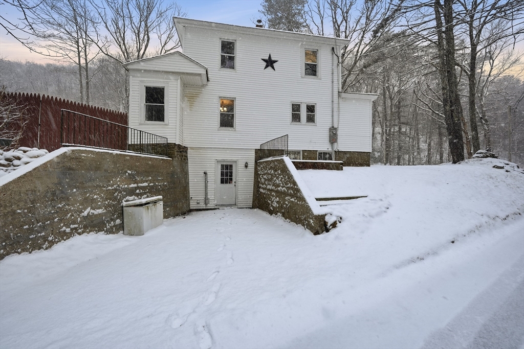 1209 Brimfield Road Warren, MA 01083 - Photo 34 of 41 a view of a white house with a snow in the yard