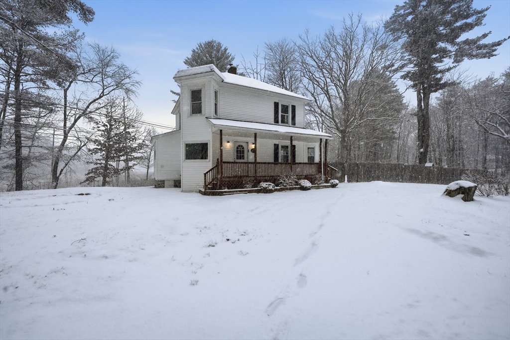 1209 Brimfield Road Warren, MA 01083 - Photo 37 of 41 a view of a white house with a yard covered in snow