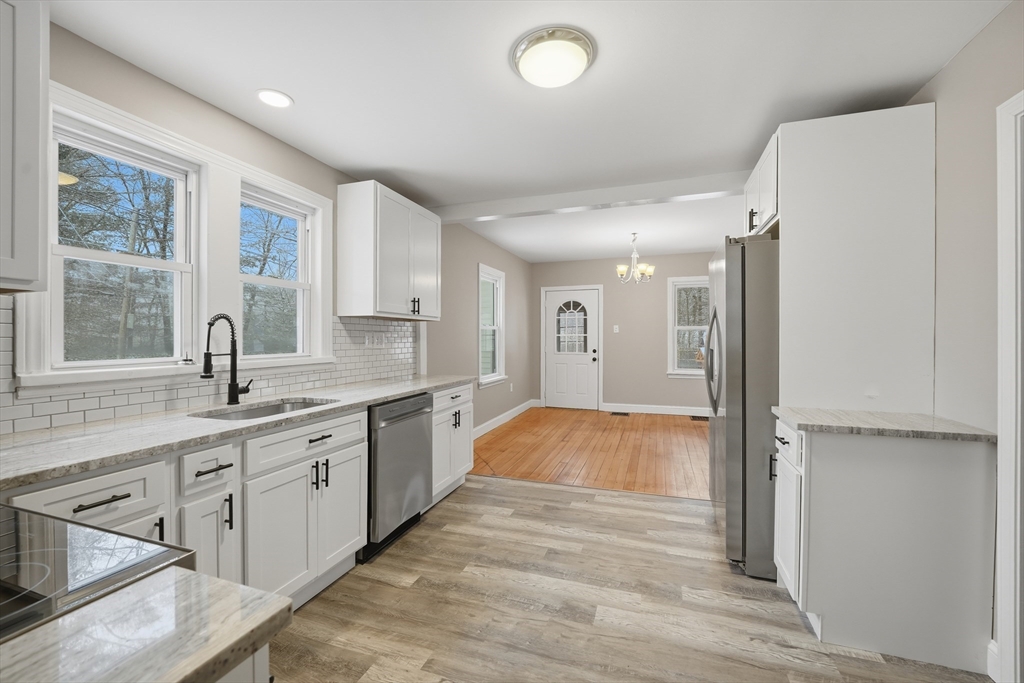 1209 Brimfield Road Warren, MA 01083 - Photo 4 of 41 a spacious bathroom with a granite countertop sink a large mirror a bathtub and next to a window