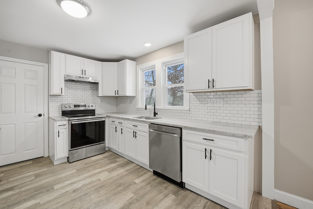 1209 Brimfield Road Warren, MA 01083 - Photo 5 of 41 a kitchen with granite countertop white cabinets and white appliances
