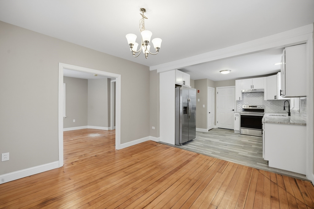 1209 Brimfield Road Warren, MA 01083 - Photo 9 of 41 a view of an empty room and kitchen with wooden floor
