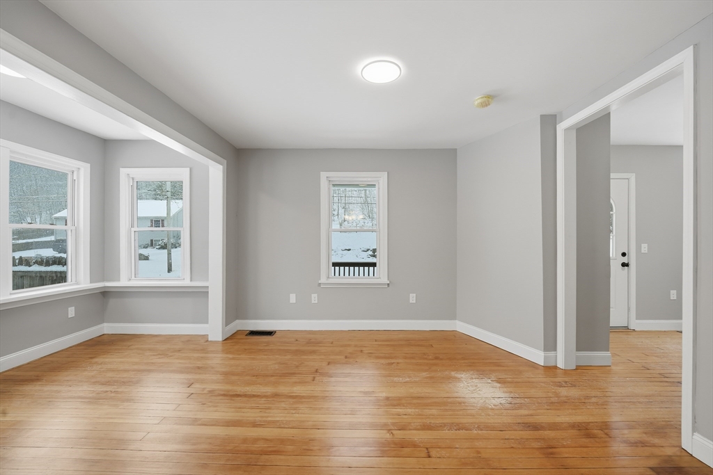 1209 Brimfield Road Warren, MA 01083 - Photo 10 of 41 an empty room with wooden floor and windows