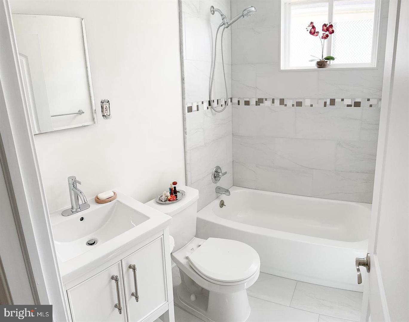 104 Clement Road, Unit D Oreland, PA 19075 - Photo 6 of 9 a bathroom with a sink mirror toilet and bathtub