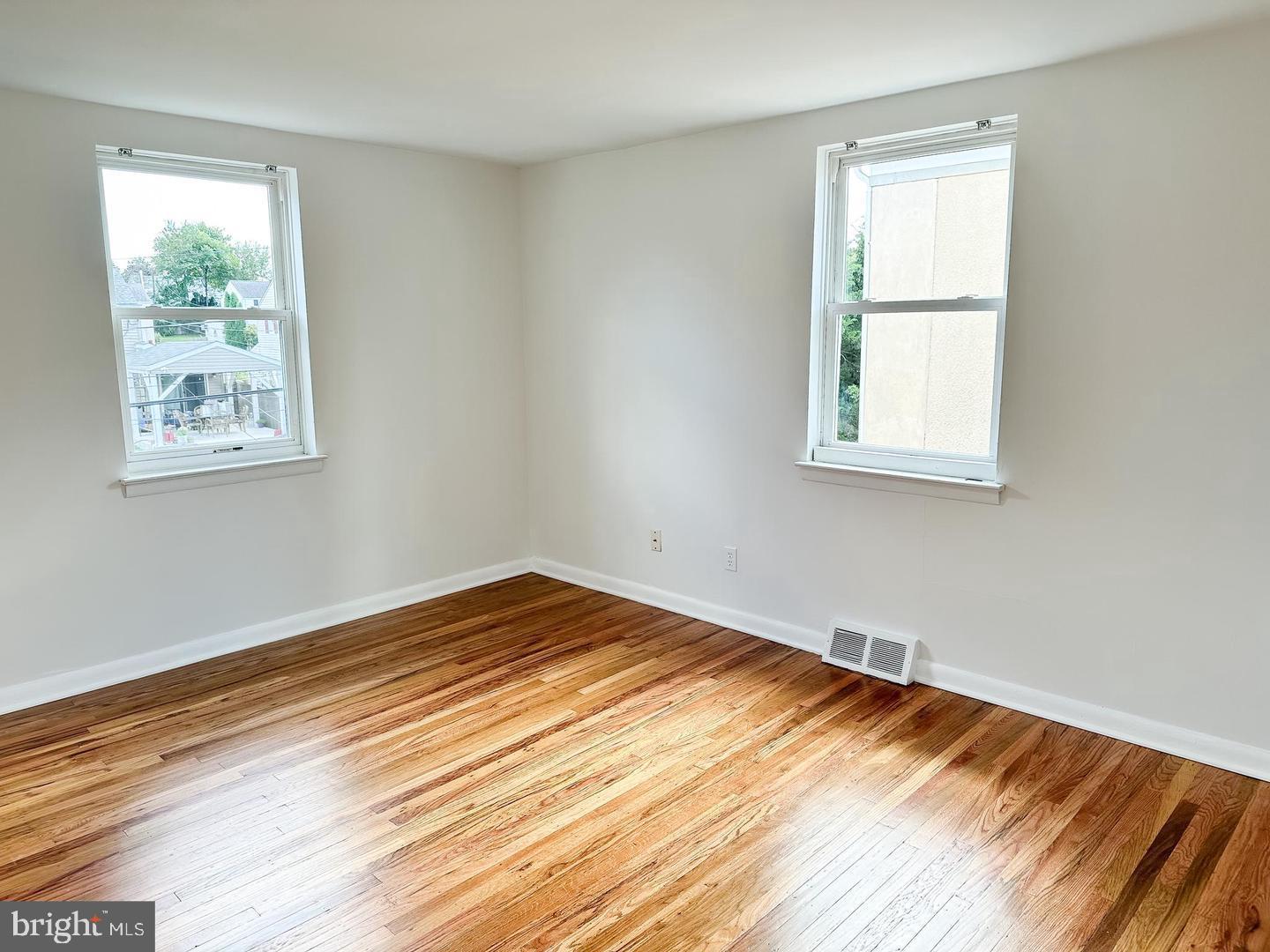104 Clement Road, Unit D Oreland, PA 19075 - Photo 7 of 9 a view of empty room with wooden floor and fan