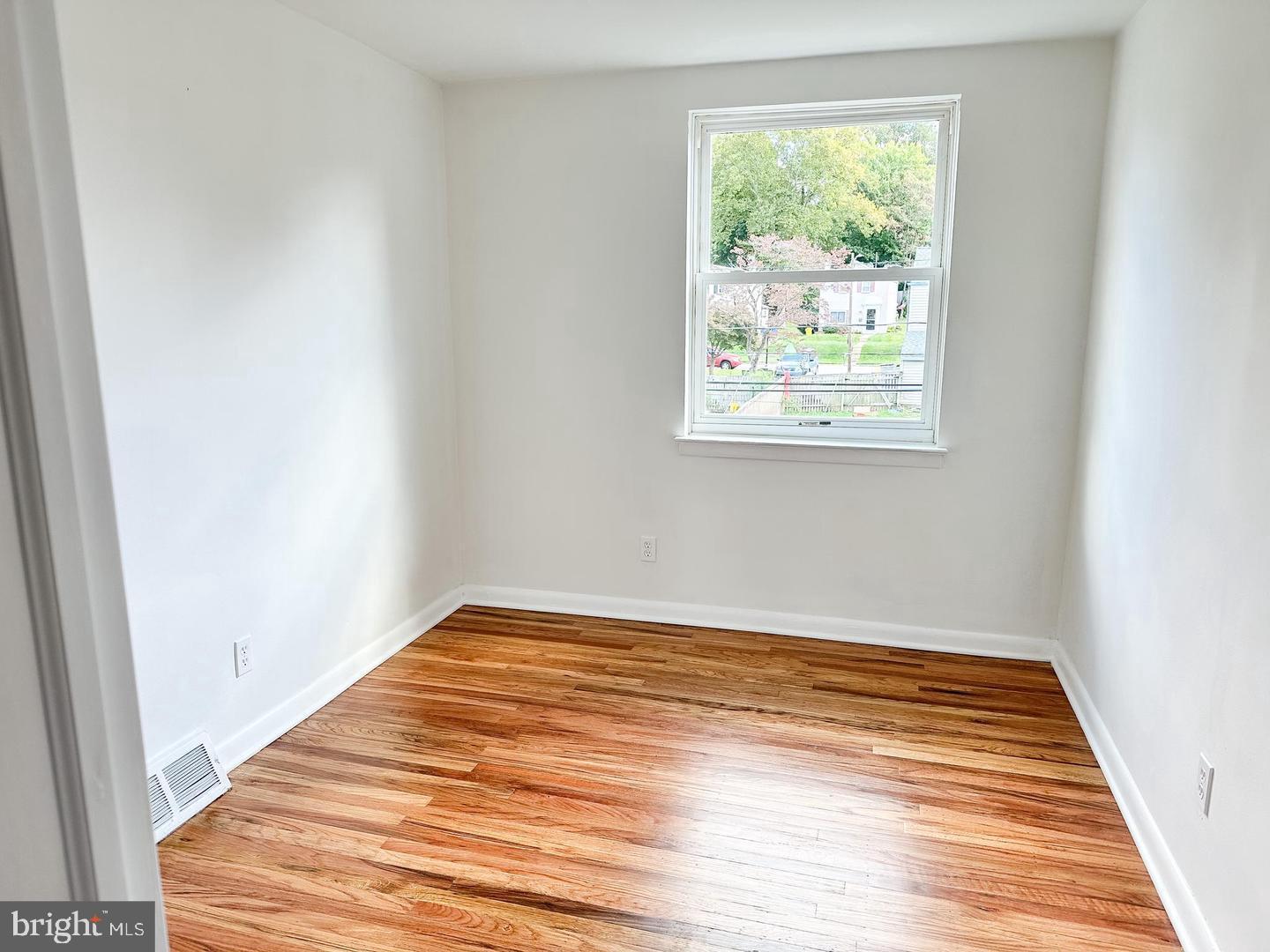 104 Clement Road, Unit D Oreland, PA 19075 - Photo 8 of 9 a view of empty room with wooden floor and fan
