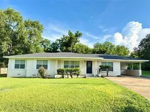a front view of house with yard patio and green space
