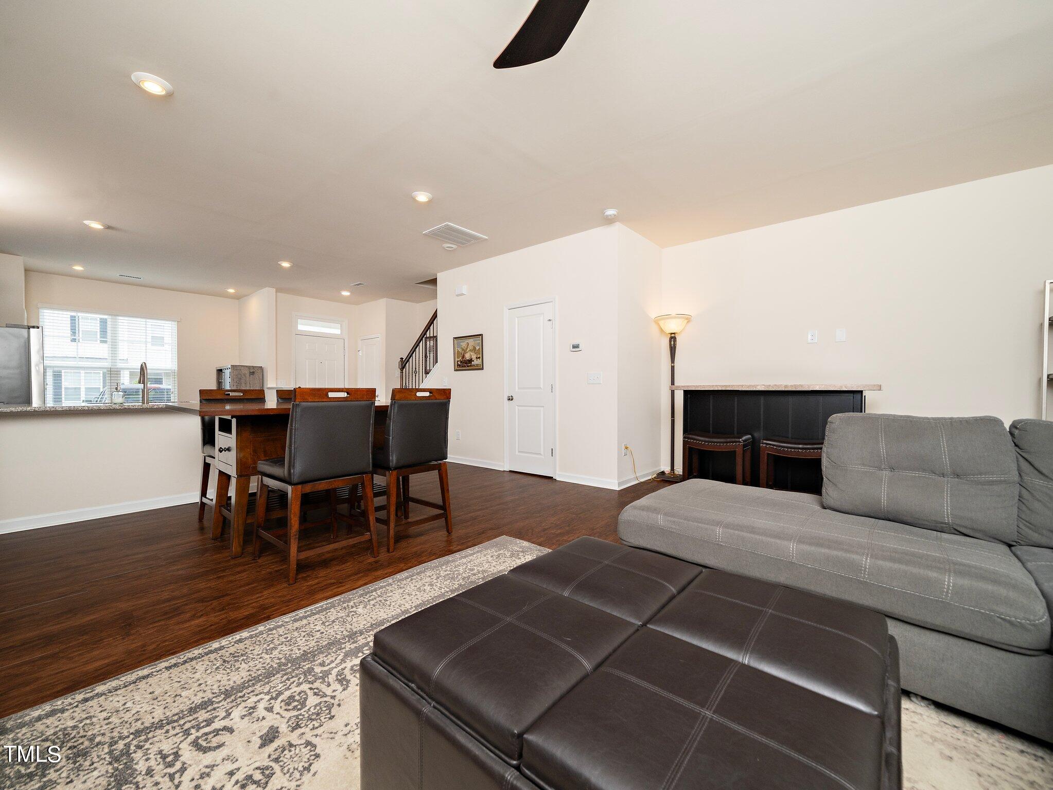 8804 Commons Townes Drive Raleigh, NC 27616 - Photo 11 of 21 a living room with furniture a dining table and kitchen view