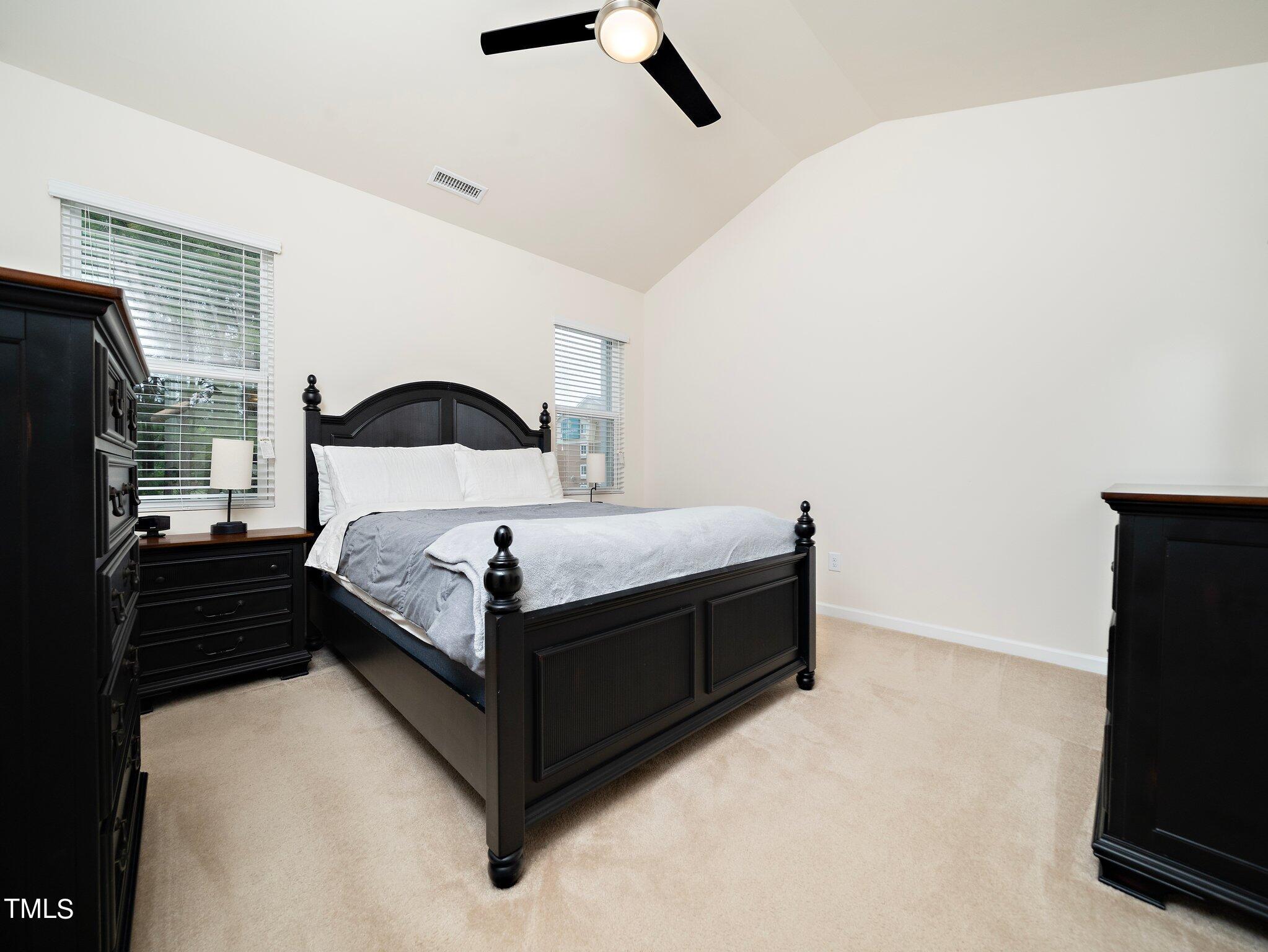 8804 Commons Townes Drive Raleigh, NC 27616 - Photo 14 of 21 a bedroom with a bed window and a flat screen tv