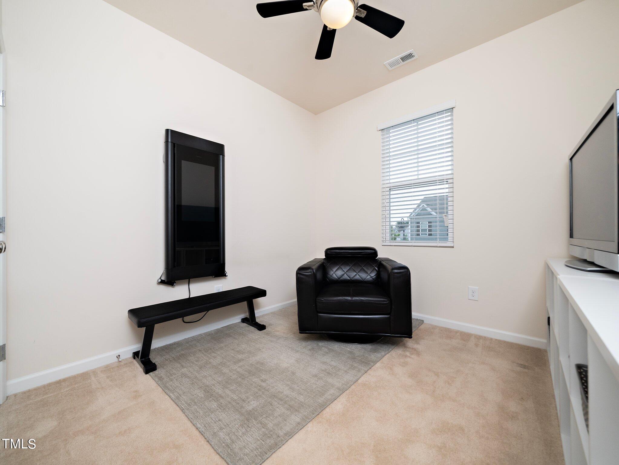 8804 Commons Townes Drive Raleigh, NC 27616 - Photo 16 of 21 a living room with furniture and a flat screen tv