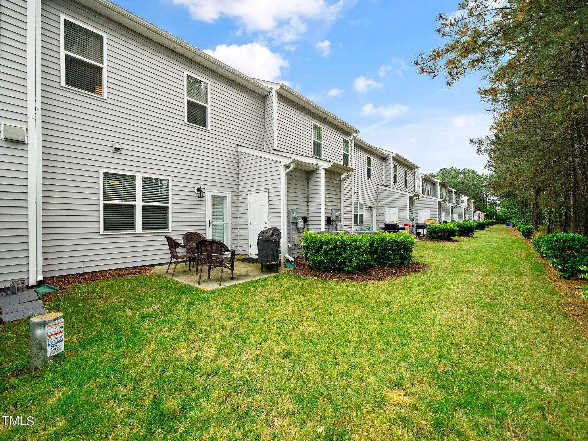 8804 Commons Townes Drive Raleigh, NC 27616 - Photo 20 of 21 a view of a house with backyard porch and sitting area