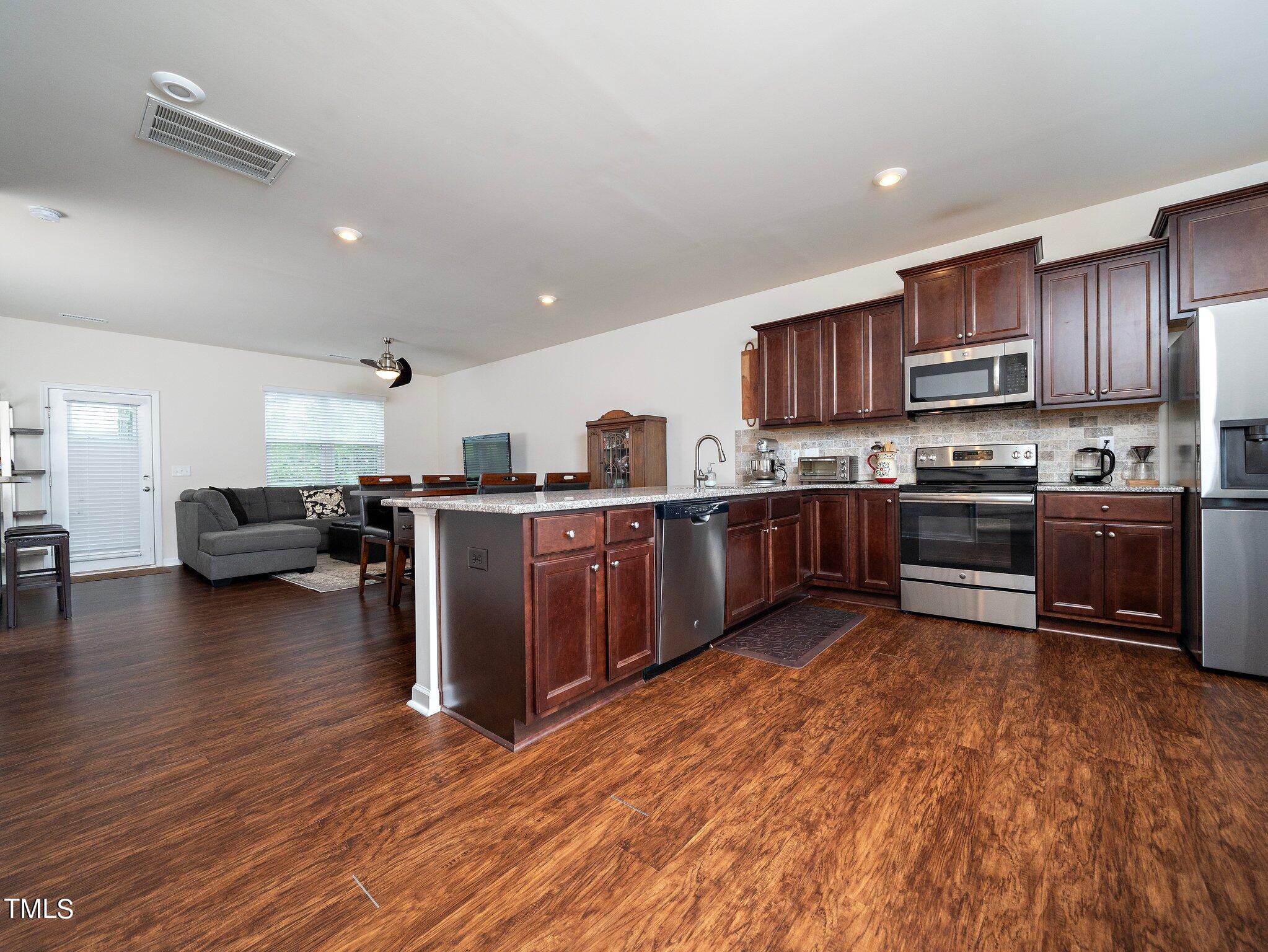 8804 Commons Townes Drive Raleigh, NC 27616 - Photo 3 of 21 a kitchen with lots of counter top space a sink and stainless steel appliances