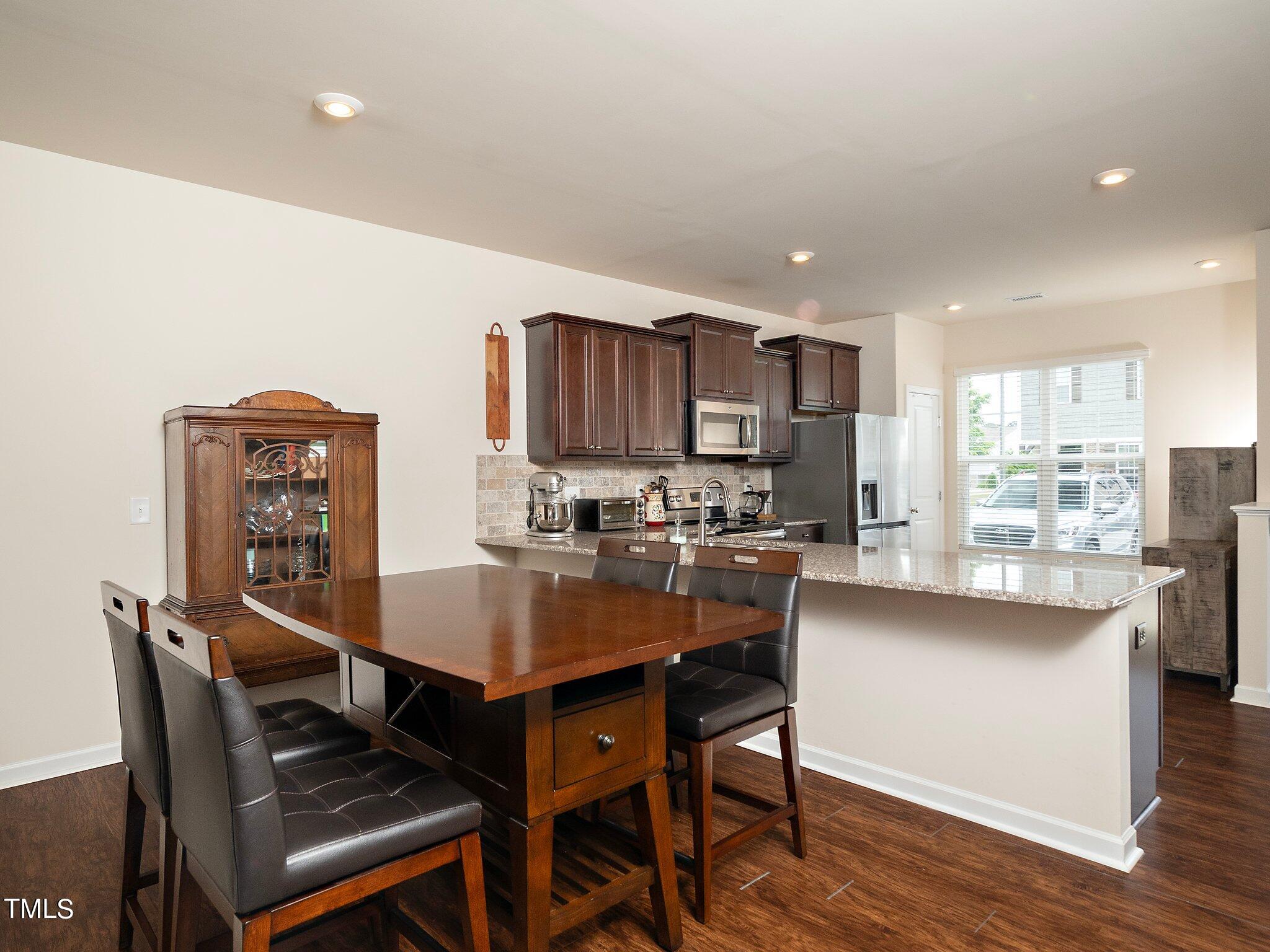 8804 Commons Townes Drive Raleigh, NC 27616 - Photo 8 of 21 a view of a dining room with furniture and wooden floor