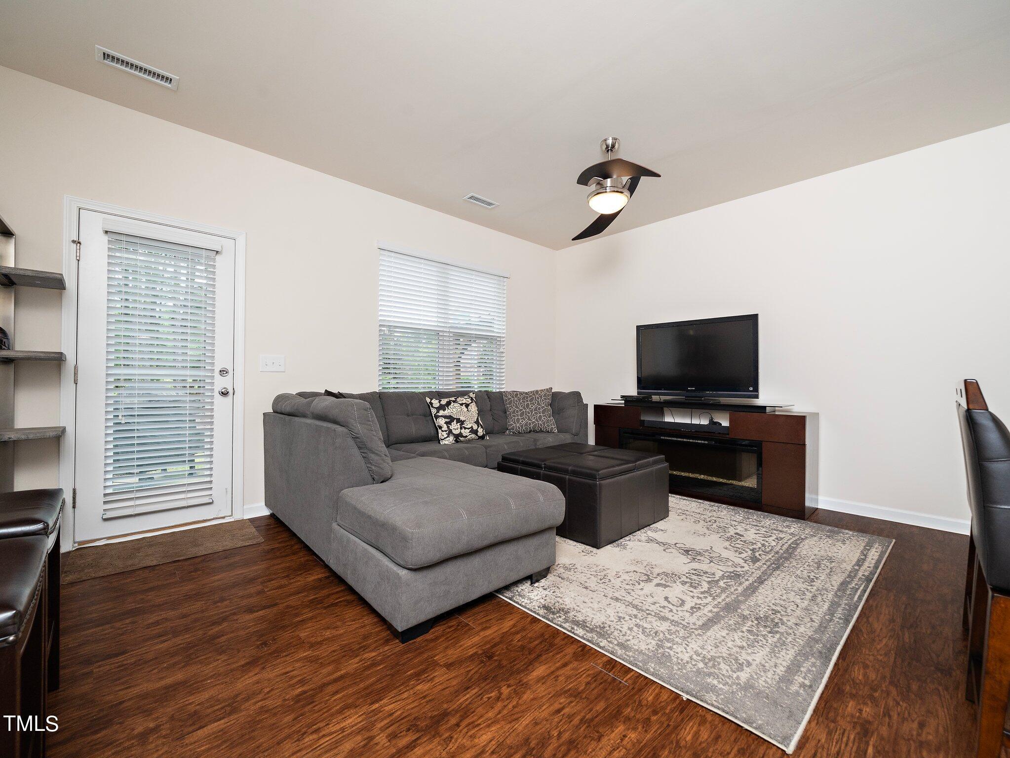 8804 Commons Townes Drive Raleigh, NC 27616 - Photo 9 of 21 a living room with furniture and a flat screen tv