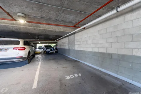 a view of parking garage with cars parked