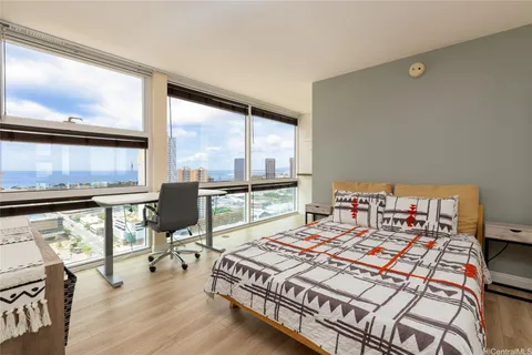 a bed sitting in a bedroom next to a window