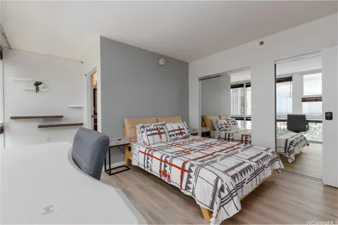 a bedroom with double bed and a couch