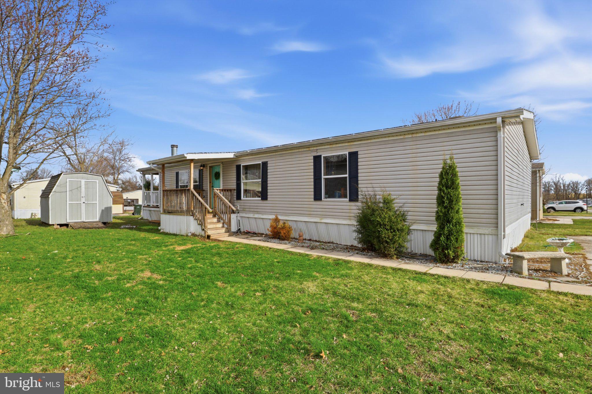 a view of a house with backyard and a tree