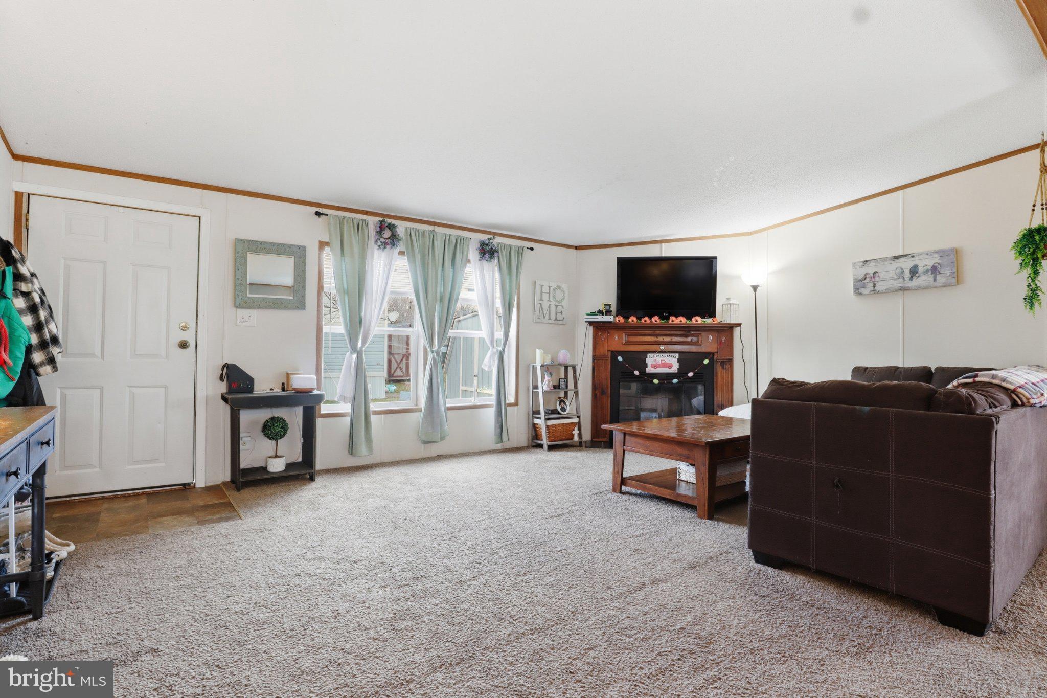 4820 Old Harrisburg Road, Unit 11 Gettysburg, PA 17325 - Photo 12 of 29 a living room with furniture and a flat screen tv